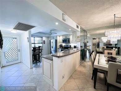EXPANSIVE GOLF/WATER/CLUBHOUSE VIEW from this Favored LUXURY on Wynmoor Golf Course in Florida - for sale on GolfHomes.com, golf home, golf lot