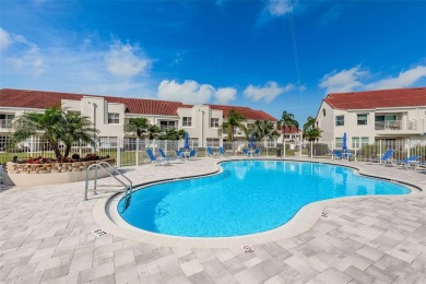 This ground-floor condo with 2 bedrooms and 2 bathrooms embodies on Isla Del Sol Yacht and Country Club in Florida - for sale on GolfHomes.com, golf home, golf lot