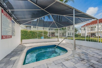 This ground-floor condo with 2 bedrooms and 2 bathrooms embodies on Isla Del Sol Yacht and Country Club in Florida - for sale on GolfHomes.com, golf home, golf lot