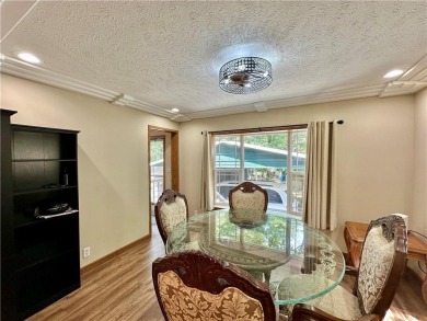 Adorable single-level home on nearly an acre of rare flat land on Holiday Island Executive Golf Course in Arkansas - for sale on GolfHomes.com, golf home, golf lot