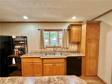 Adorable single-level home on nearly an acre of rare flat land on Holiday Island Executive Golf Course in Arkansas - for sale on GolfHomes.com, golf home, golf lot