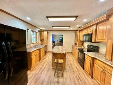 Adorable single-level home on nearly an acre of rare flat land on Holiday Island Executive Golf Course in Arkansas - for sale on GolfHomes.com, golf home, golf lot