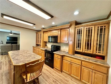 Adorable single-level home on nearly an acre of rare flat land on Holiday Island Executive Golf Course in Arkansas - for sale on GolfHomes.com, golf home, golf lot