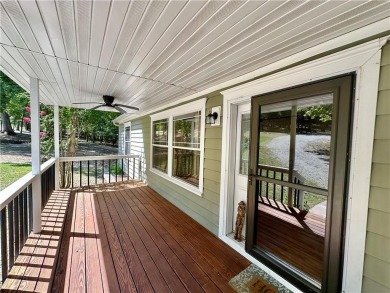 Adorable single-level home on nearly an acre of rare flat land on Holiday Island Executive Golf Course in Arkansas - for sale on GolfHomes.com, golf home, golf lot