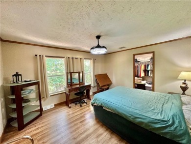 Adorable single-level home on nearly an acre of rare flat land on Holiday Island Executive Golf Course in Arkansas - for sale on GolfHomes.com, golf home, golf lot