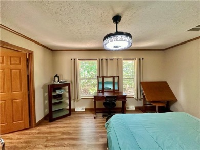 Adorable single-level home on nearly an acre of rare flat land on Holiday Island Executive Golf Course in Arkansas - for sale on GolfHomes.com, golf home, golf lot