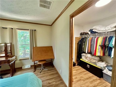 Adorable single-level home on nearly an acre of rare flat land on Holiday Island Executive Golf Course in Arkansas - for sale on GolfHomes.com, golf home, golf lot