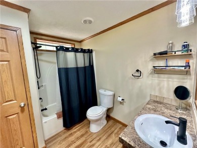 Adorable single-level home on nearly an acre of rare flat land on Holiday Island Executive Golf Course in Arkansas - for sale on GolfHomes.com, golf home, golf lot