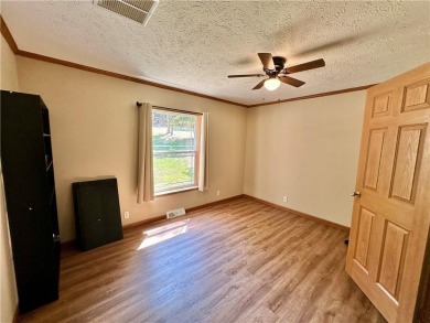 Adorable single-level home on nearly an acre of rare flat land on Holiday Island Executive Golf Course in Arkansas - for sale on GolfHomes.com, golf home, golf lot