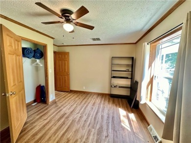 Adorable single-level home on nearly an acre of rare flat land on Holiday Island Executive Golf Course in Arkansas - for sale on GolfHomes.com, golf home, golf lot