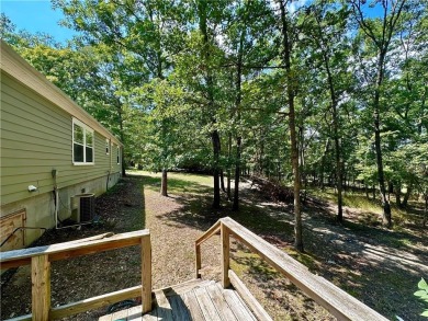 Adorable single-level home on nearly an acre of rare flat land on Holiday Island Executive Golf Course in Arkansas - for sale on GolfHomes.com, golf home, golf lot