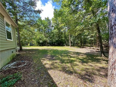 Adorable single-level home on nearly an acre of rare flat land on Holiday Island Executive Golf Course in Arkansas - for sale on GolfHomes.com, golf home, golf lot