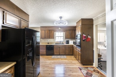 This beautifully updated home is located in a private gated on Canongate At Healy Point Country Club in Georgia - for sale on GolfHomes.com, golf home, golf lot