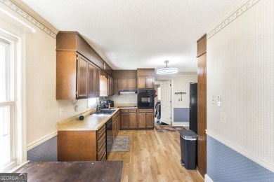 This beautifully updated home is located in a private gated on Canongate At Healy Point Country Club in Georgia - for sale on GolfHomes.com, golf home, golf lot