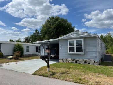 Nicely maintained furnished home on nice lot with no rear on Lake Henry Golf Club in Florida - for sale on GolfHomes.com, golf home, golf lot