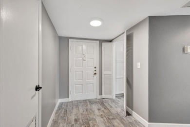 BEAUTIFULLY UPDATED FIRST FLOOR CORNER UNIT, PRIVATE & IDEALLY on BallenIsles Golf and Country Club in Florida - for sale on GolfHomes.com, golf home, golf lot