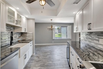 BEAUTIFULLY UPDATED FIRST FLOOR CORNER UNIT, PRIVATE & IDEALLY on BallenIsles Golf and Country Club in Florida - for sale on GolfHomes.com, golf home, golf lot