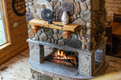 Stunning, custom-built log home overlooking the 16th tee & on Cedar River Golf Course in Michigan - for sale on GolfHomes.com, golf home, golf lot