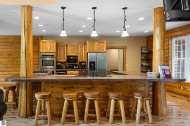 Stunning, custom-built log home overlooking the 16th tee & on Cedar River Golf Course in Michigan - for sale on GolfHomes.com, golf home, golf lot