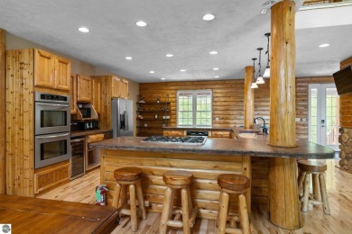 Stunning, custom-built log home overlooking the 16th tee & on Cedar River Golf Course in Michigan - for sale on GolfHomes.com, golf home, golf lot