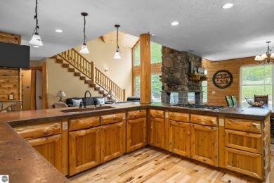 Stunning, custom-built log home overlooking the 16th tee & on Cedar River Golf Course in Michigan - for sale on GolfHomes.com, golf home, golf lot