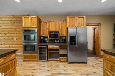 Stunning, custom-built log home overlooking the 16th tee & on Cedar River Golf Course in Michigan - for sale on GolfHomes.com, golf home, golf lot