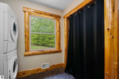 Stunning, custom-built log home overlooking the 16th tee & on Cedar River Golf Course in Michigan - for sale on GolfHomes.com, golf home, golf lot
