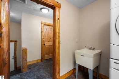 Stunning, custom-built log home overlooking the 16th tee & on Cedar River Golf Course in Michigan - for sale on GolfHomes.com, golf home, golf lot