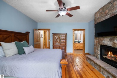 Stunning, custom-built log home overlooking the 16th tee & on Cedar River Golf Course in Michigan - for sale on GolfHomes.com, golf home, golf lot