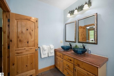 Stunning, custom-built log home overlooking the 16th tee & on Cedar River Golf Course in Michigan - for sale on GolfHomes.com, golf home, golf lot