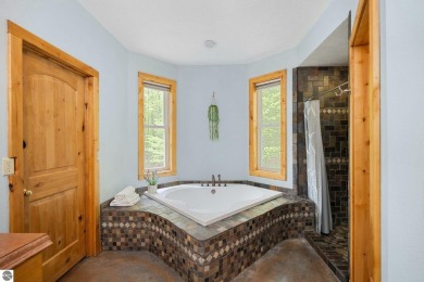 Stunning, custom-built log home overlooking the 16th tee & on Cedar River Golf Course in Michigan - for sale on GolfHomes.com, golf home, golf lot