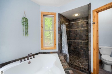 Stunning, custom-built log home overlooking the 16th tee & on Cedar River Golf Course in Michigan - for sale on GolfHomes.com, golf home, golf lot