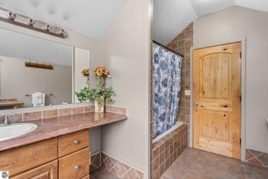 Stunning, custom-built log home overlooking the 16th tee & on Cedar River Golf Course in Michigan - for sale on GolfHomes.com, golf home, golf lot