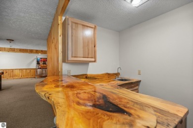 Stunning, custom-built log home overlooking the 16th tee & on Cedar River Golf Course in Michigan - for sale on GolfHomes.com, golf home, golf lot