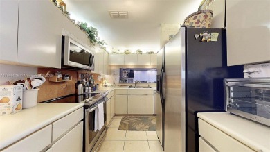 Charming and impeccably maintained 2-bedroom, 2-bath townhouse on Jim McLean Signature Course in Florida - for sale on GolfHomes.com, golf home, golf lot