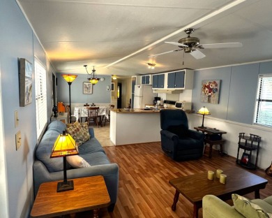 Discover comfort and charm in this beautifully updated 2-bedroom on Lake Henry Golf Club in Florida - for sale on GolfHomes.com, golf home, golf lot