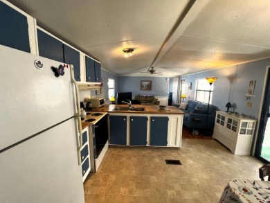 Discover comfort and charm in this beautifully updated 2-bedroom on Lake Henry Golf Club in Florida - for sale on GolfHomes.com, golf home, golf lot