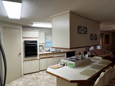 This beautifully maintained 2-bedroom, 2-bathroom Homes of Merit on Lake Henry Golf Club in Florida - for sale on GolfHomes.com, golf home, golf lot