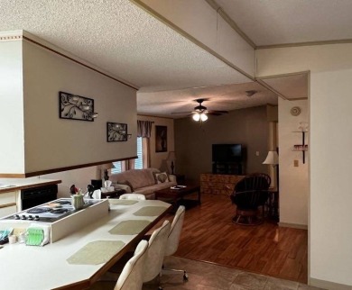 This beautifully maintained 2-bedroom, 2-bathroom Homes of Merit on Lake Henry Golf Club in Florida - for sale on GolfHomes.com, golf home, golf lot