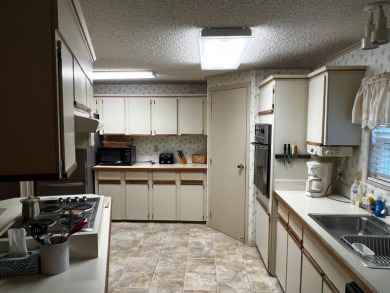 This beautifully maintained 2-bedroom, 2-bathroom Homes of Merit on Lake Henry Golf Club in Florida - for sale on GolfHomes.com, golf home, golf lot