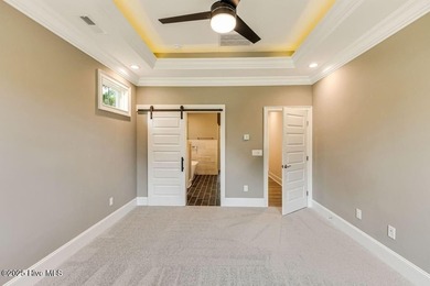 This brand new Riptide home with stunning setting and finishes on Sea Trail Golf Resort in North Carolina - for sale on GolfHomes.com, golf home, golf lot