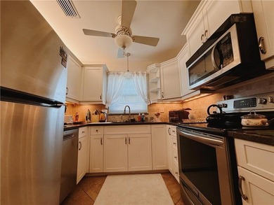 Golf + water views from this completely redone, fully furnished on The American Golf Club in Florida - for sale on GolfHomes.com, golf home, golf lot