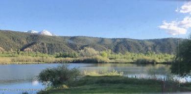 Rarely available and highly desirable ground floor pondside on Ranch at Roaring Fork Golf Course in Colorado - for sale on GolfHomes.com, golf home, golf lot