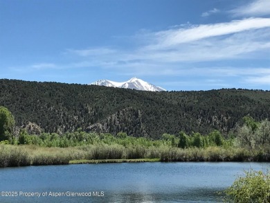 Rarely available and highly desirable ground floor pondside on Ranch at Roaring Fork Golf Course in Colorado - for sale on GolfHomes.com, golf home, golf lot