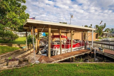 WATERFRONT 2 BED/2 BATH CORNER LOT - BOATHOUSE w/ LIFT - VIBRANT on Bay Tree Golf Course in Florida - for sale on GolfHomes.com, golf home, golf lot