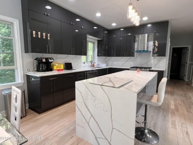 Discover this ultra modern, newly renovated 4-bedroom, 2.5 bath on Country Club of the Poconos Golf Course in Pennsylvania - for sale on GolfHomes.com, golf home, golf lot