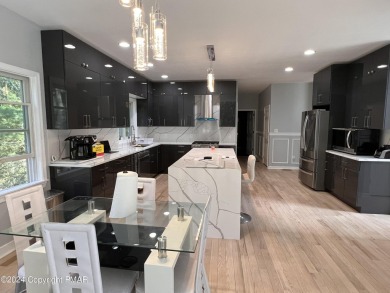 Discover this ultra modern, newly renovated 4-bedroom, 2.5 bath on Country Club of the Poconos Golf Course in Pennsylvania - for sale on GolfHomes.com, golf home, golf lot