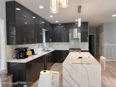 Discover this ultra modern, newly renovated 4-bedroom, 2.5 bath on Country Club of the Poconos Golf Course in Pennsylvania - for sale on GolfHomes.com, golf home, golf lot