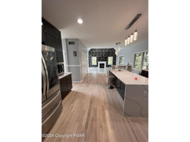 Discover this ultra modern, newly renovated 4-bedroom, 2.5 bath on Country Club of the Poconos Golf Course in Pennsylvania - for sale on GolfHomes.com, golf home, golf lot