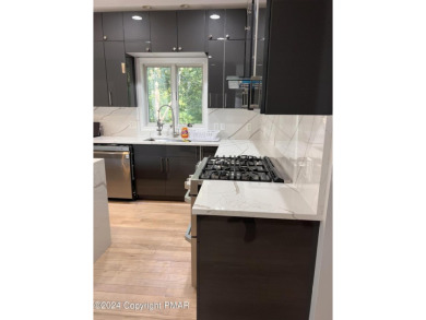 Discover this ultra modern, newly renovated 4-bedroom, 2.5 bath on Country Club of the Poconos Golf Course in Pennsylvania - for sale on GolfHomes.com, golf home, golf lot